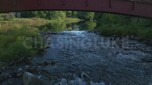 Static Aerial Under Red Bridge Over Tay River Rapids