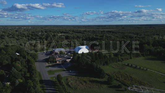 Aerial Toward Lanark County Buildings and Trees Concealing Round Garden