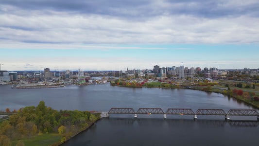 Descending Aerial Over Ottawa River with Autumn Colour and Pedestrian Bridge