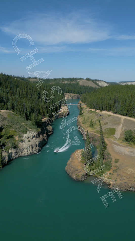 Boat Speeds Through Miles Canyon in Summer Aerial View