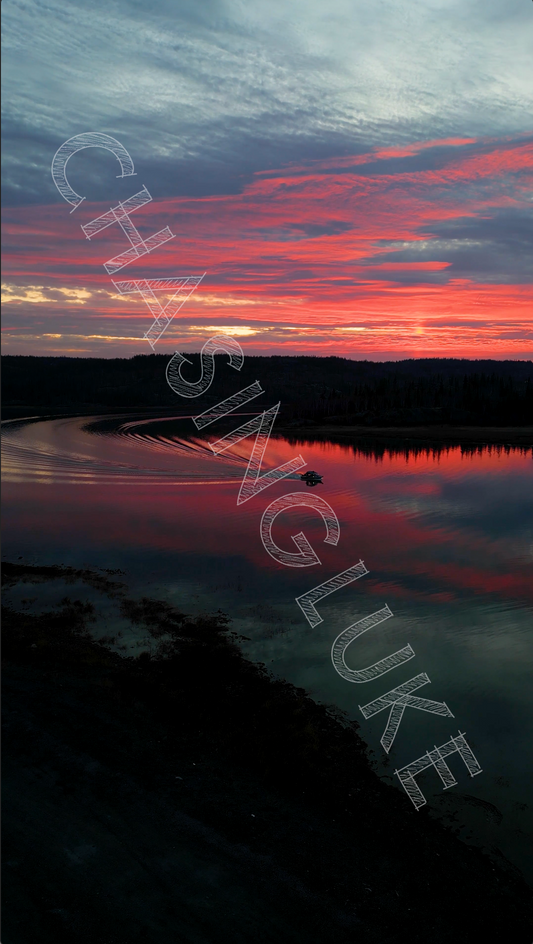 Motorboat Rounds the Bend on Prosperous Lake Under Fiery Sunset Clouds