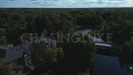 Pullback Aerial Over Tay River Toward Rogers Road Bridge With Vehicle Crossing